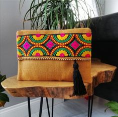 This bohemian handbag will bring elegance to your style. It will be chic with jeans or dresses and you may use this clutch bag both day and night.  This clutch bag is perfectly handmade with high quality mustard yellow jute fabric. Designed with a silk bohemian embroidery and a tassel. Clutch has a silk satin interfacing and a padding inside to stand upright. Closes with a magnet closing.  This bag is designed to fit all the things you need for comfortable everyday busy life. There will be enoug Bohemian Clutch, Bohemian Embroidery, Bohemian Handbags, Boho Clutch, Diy Sac, Embroidered Handbag, Jute Fabric, Floral Clutches, Bohemian Bags