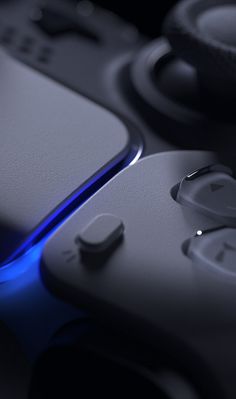 a close up view of a video game controller with blue light coming from the side