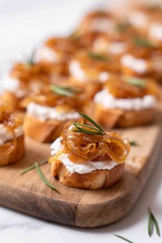 small appetizers are arranged on a wooden platter