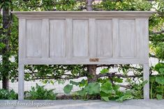 an old wooden cabinet sitting under a tree