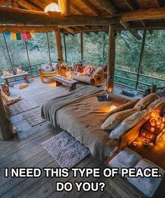 a bed sitting on top of a wooden floor next to a covered area with lots of windows