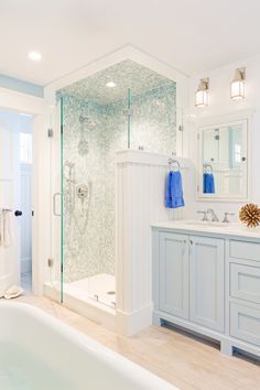 a bathroom with a tub, sink and shower in it's own area is shown