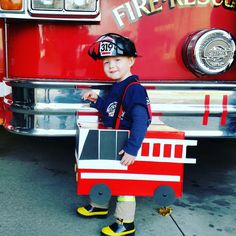 a young boy dressed up as a fire truck