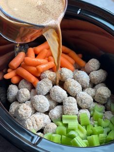 carrots, celery and meatballs are being poured into the slow cooker