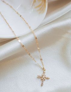 ⭐️ Sparkling Cross Necklace ⭐️ Made with the following: Gold Plated Cubic Zirconia Cross 24mm x 18mm 14K Gold Filled Findings 14K Gold Filled Spring Clasp 14K Gold Filled Chain Please select the chain and length from the drop down menu. The length does not include the pendant. Please select if you would like a 2 inch extender chain from the drop down menu. This listing is for one necklace. The last picture shows the necklace paired with the Mini Paperclip Necklace and Sweet to the Soul Necklace Delicate Cross Jewelry Gift, Elegant Pendant Cross Necklace As Gift, Elegant Pendant Cross Necklace For Gift, Elegant Cross Charm Necklace With Adjustable Chain, Delicate Clavicle Chain Jewelry With Cross Pendant, Elegant Cross Pendant Necklace As Gift, Elegant Clavicle Chain Cross Necklace For Gift, Elegant Cross Pendant Necklace For Gift, Dainty Cross Necklace For Gift