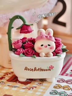 there is a small figurine in the bathtub with pink roses on it