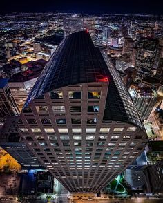 an aerial view of skyscrapers at night with lights in the windows and buildings lit up