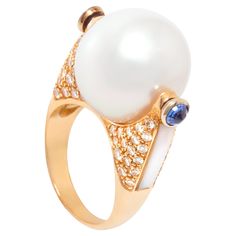 The South Sea pearl and diamond ring features a pearl of 16mm diameter. The pearl is untreated. It displays a splendid nacre and its natural color and luster have not been enhanced in any way. The pearl is flanked by 2 cabochon sapphires and a strip of custom cut mother-of-pearl. The rose gold design is complete with a pavé of round diamonds for the weight of approximately 1 carat. All diamonds are of top quality (F/G-VVS, color, clarity and cut). The ring is one-of-a-kind. It was handmade in It Luxury Gold Pearl Ring With Diamonds, Luxury Fine Jewelry Pearl Ring With Single Diamond, Luxury Pearl Ring With Rose Cut Diamonds, Luxury Diamond Pearl Ring With High Luster, Luxury Pearl Cabochon Ring, Fancy Diamond Ring, Pearl Rose, Pearl And Diamond Ring, Rose Gold Diamond Ring