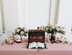 a table topped with an open book and flowers