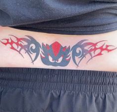 a man with a tattoo on his stomach that has red and black flames coming out of it