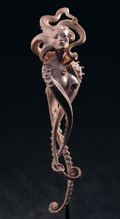 a sculpture of a woman with an octopus on it's back