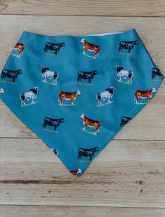 a blue bandana with cows on it