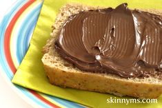 a piece of bread with chocolate frosting on it sitting on top of a plate