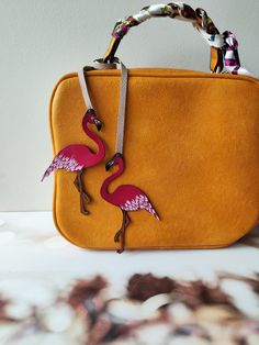 "This is 100 % handmade work. Make a bag unique! This Flamingo bag charm is handmade from premium leather and hand painted. The leather purse charm is just beautiful. This unique handmade leather charm would make a lovely gift for any Birds lover. The leather bag charm could also be given as a little gift for a friend or sister! Completely handcrafted as the hand cut leather is hand-painted and hand-burnished. Width of Flamingo approximately 2.5 inches (6.5 cm). Height of Flamingo approximately Miniature Objects, Flamingo Bag, Make A Bag, Handbags Handmade, Custom Handbags, Unique Roses, Bag Charms, Handbag Charms, Veg Tan Leather