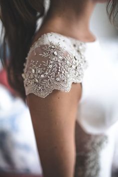 the back of a woman's shoulder with lace on it