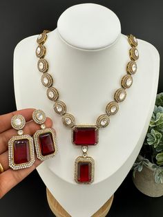 Premium Quality. This is a beautiful Premium uncut kundan necklace set with big Maroon Glass stones and matching earrings has amazing shine. This set goes well with Indian as well as western outfit. This is so beautiful to look at and a perfect one for Indian weddings.  Color : gold and Maroon Necklace length : 16 inch Earring length : 2.1 inch Earring width : 0.9 inch Each Earring Weight: 12.3 Grams Material : moissanite Kundan, CZ, Glass Stone Beautiful High Quality, premium jewelry. Free US s