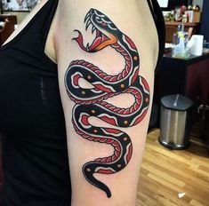 a black and red snake tattoo on the arm