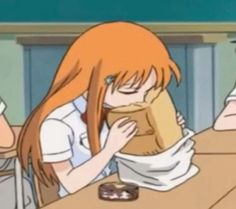 two people sitting at a table with donuts in front of them and one is eating