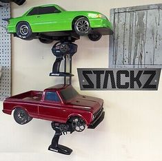 two toy cars are on top of each other in the shape of an upside down car