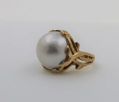 14K yellow gold round shaped real pearl ring with a matte finish. Gorgeous pearl fashion ring. This classic ring would be a great addition to anybody's collection. Ring size: 5.5 Pearl measures approx: 20.4mm X 19.2mm Total ring weight: 11.5g Will be placed into a suitable gift box. Free shipping within the U.S. Classic Gold Pearl Ring With High Luster, Yellow Gold Pearl Ring With High Luster, Gold Pearl Ring With Polished Finish, Formal Gold-plated Pearl Ring, Big Pearl Ring, Elegant Gold-plated Pearl Ring For Formal Occasions, Big Pearl, White Band, Real Pearls