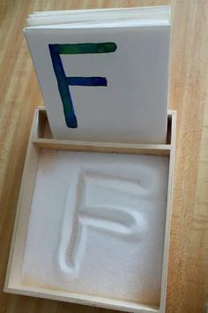 an open box with the letter f painted on it