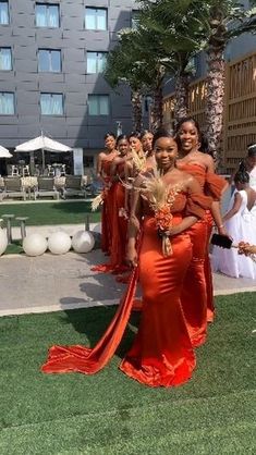 the bridesmaids are all dressed in orange