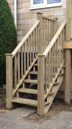 a wooden staircase next to a brick building