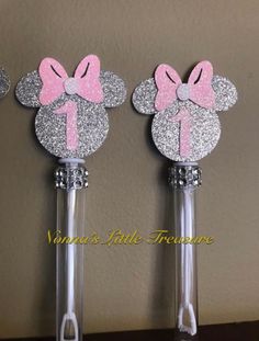 three minnie mouse hair brushes with pink bows on them, one is silver and the other is white