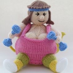 a knitted doll sitting on top of a white surface