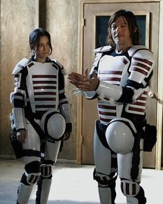 two people in costumes standing next to each other with one person wearing a robot suit