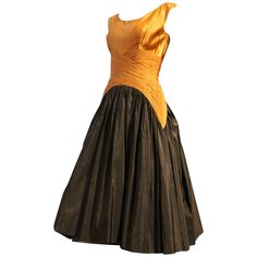 A beautiful 1950s Samuel Winston cocktail dress with full black taffeta skirt and exquisite bodice detailing in gold silk satin and ruched chiffon.Back zipper and organza and horsehair underskirt. Black Gold Cocktail Dress, Black And Gold Cocktail, 1920s Evening Dress, Informal Dress, Rouched Dress, Gold Cocktail Dress, Gold And Black Dress, Italian Dress, Ivory Lace Dress