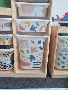 the storage bins are filled with different types of dishes and containers for children's play