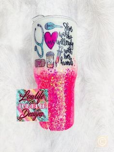 the pink glitter tumbler is next to a sticker