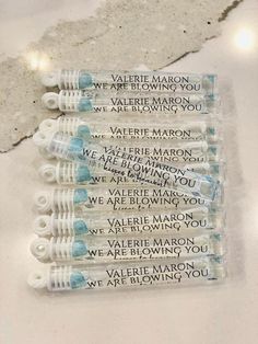 four baby bottles with writing on them sitting next to each other in front of a wall