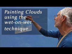 a man painting clouds using the wet - on - wet technique with text overlay