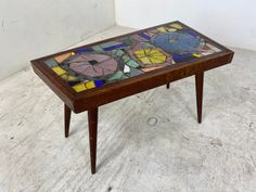 a wooden table with stained glass on top