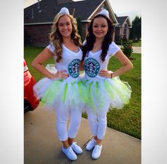 two girls dressed up in costumes standing next to each other