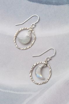 The Mystic earrings showcase a sweet and simple moon focal. At 1 inch, their sterling silver ear wires give them a polished finish. Sterling Silver (Lead & Nickel Free) Rainbow Moonstone 1" with sterling silver ear wires We hand select our natural materials, thus there may be slight variations in color and/or size that will not detract from the overall aesthetic. Our unique handcrafted designer jewelry for women is made in America, each design created individually in our personal design studio i Silver Moon Earrings, Floyd Va, The Mystic, Bracelet Design, Moonstone Earrings, Silver Moon, Moon Earrings, Simple Earrings, Designer Jewelry