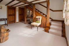 a chair sitting on top of a white carpeted floor next to a stair case