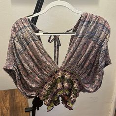 Brand: Free People Type: Crop Top, Short Sleeves Size: L Color: Purple & Pink W/ Pattern Material: 62% Cotton & 38% Modal Condition: New, Never Worn Lavender V-neck Top For Vacation, Purple V-neck Beach Top, Floral Print Lavender Top For Vacation, Lavender Floral Print Top For Vacation, Purple V-neck Top For Summer, Purple Floral Print Summer Top, Summer Floral Print Purple Tops, Summer Purple Floral Print Top, Purple V-neck Top For Day Out