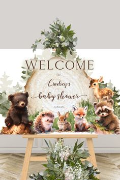 a welcome sign with baby animals on it in front of a forest scene and foliage