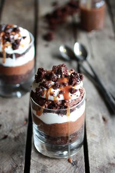 two desserts in small glass containers with spoons