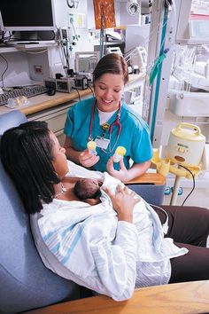 a woman in a hospital bed holding a baby