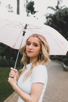 a woman holding an umbrella in her hand