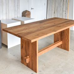 a wooden table sitting on top of a white floor