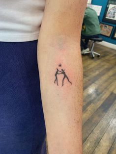 a person with a small tattoo on their arm