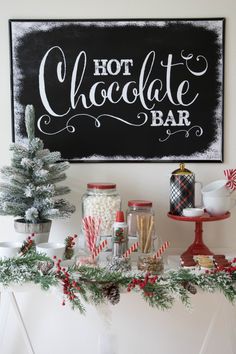 a sign that says hot chocolate bar with candy canes and candies on it