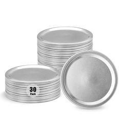 a stack of silver plates sitting next to each other