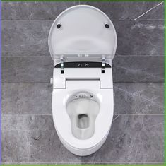 an overhead view of a toilet with the lid open and seat up, on a tile floor