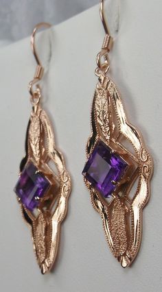 "Natural Amethyst Earrings Star Design#E6 Custom Made These are Victorian era reproduction earrings (Made from and Antique brooch) in sterling silver set with flawless high quality natural purple amethyst gemstones. Each stunning 1ct Amethyst is 6mm long/wide (1/4th\"). The earrings are 1 3/4th inches long and 14mm (1/2\") at its widest point. Notice the beautiful leaf on the bottom and top of the setting. These lovely earrings were fashioned from an antique Victorian floral brooch. A gift box i Purple Earrings With Intricate Design For Gift, Purple Earrings With Intricate Design As Gift, Ornate Purple Drop Earrings, Ornate Purple Dangle Jewelry, Ornate Purple Jewelry With Matching Earrings, Rose Gold Filigree Dangle Jewelry, Ornate Purple Pierced Earrings, Elegant Purple Jewelry With Ear Wire, Elegant Purple Pierced Jewelry